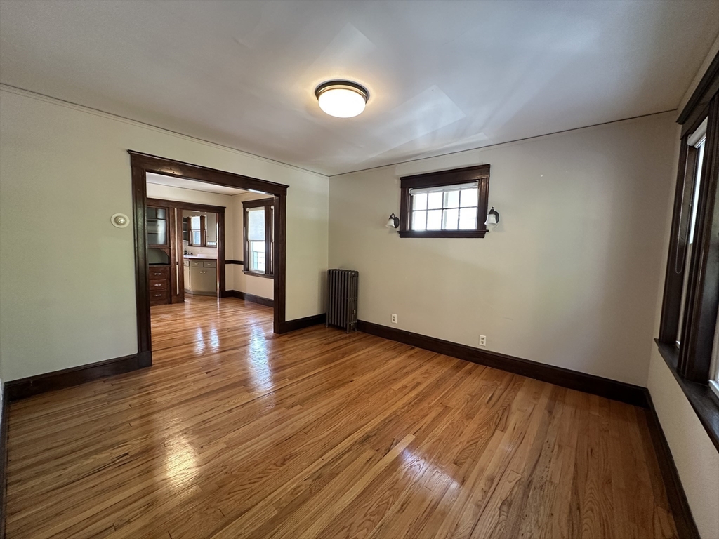 77 Walk Hill Street, Unit 1 Boston, MA 02130 - Photo 3 of 29 an empty room with wooden floor and windows
