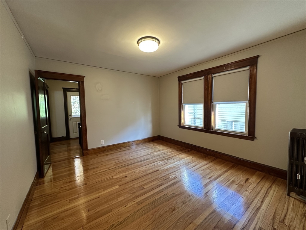 77 Walk Hill Street, Unit 1 Boston, MA 02130 - Photo 6 of 29 wooden floor in an empty room with a window