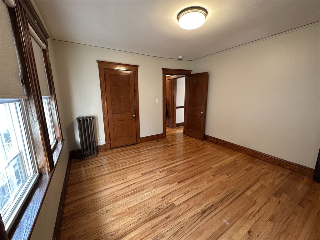 77 Walk Hill Street, Unit 1 Boston, MA 02130 - Photo 8 of 29 a view of a livingroom with wooden floor and stairs
