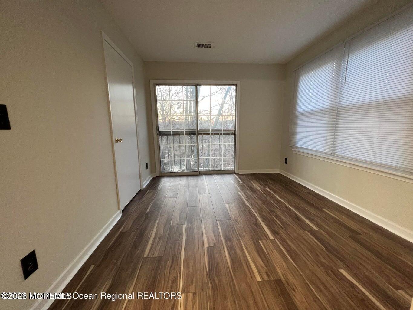 12-7 Phoenix Court Freehold, NJ 07728 - Photo 11 of 12 a view of a room with wooden floor and window