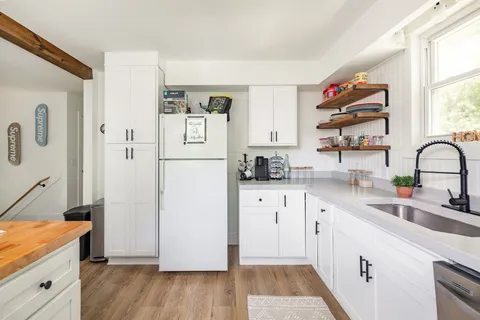 a kitchen with a refrigerator and a sink