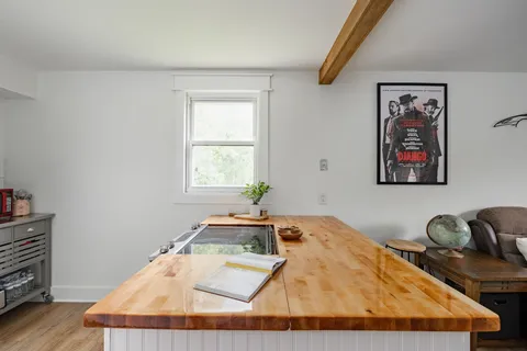 a room with a bed and wooden floor