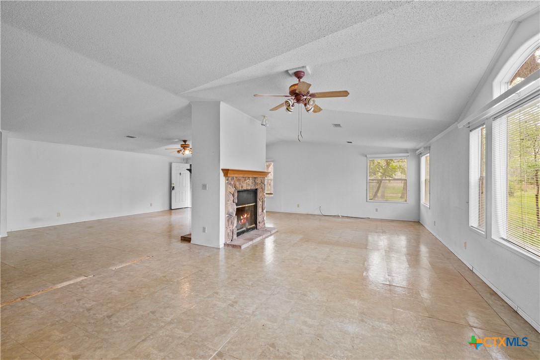 1189 Vivroux Ranch Road Seguin, TX 78155 - Photo 7 of 34 living room with double sided fireplace