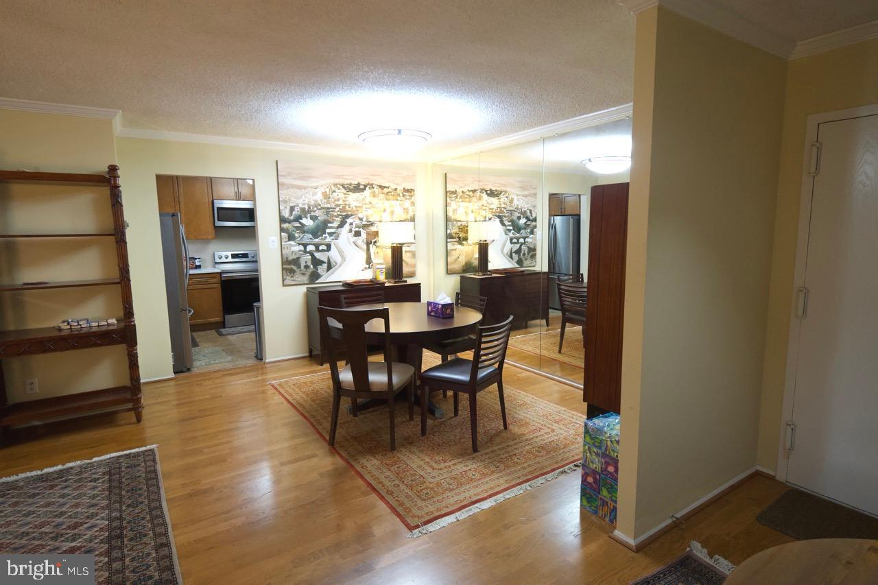 1800 Old Meadow Road, Unit 818 McLean, VA 22102 - Photo 9 of 35 a view of a dining room with furniture window and wooden floor