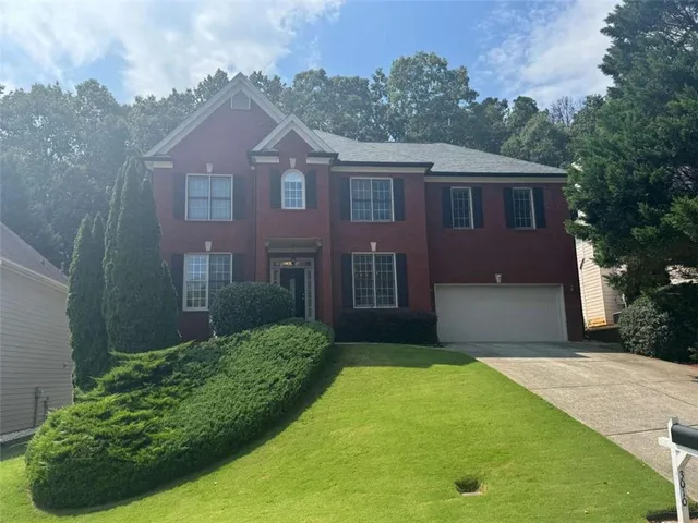 a front view of a house with a yard