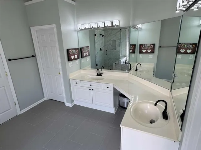 a bathroom with a double vanity sink and mirror