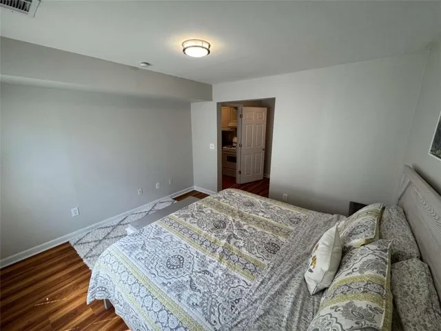 a bedroom with a bed and painting on the wall