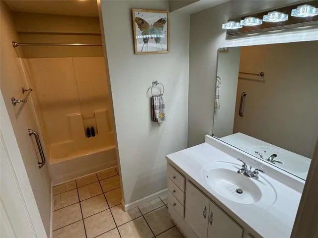 a bathroom with a sink vanity and a mirror