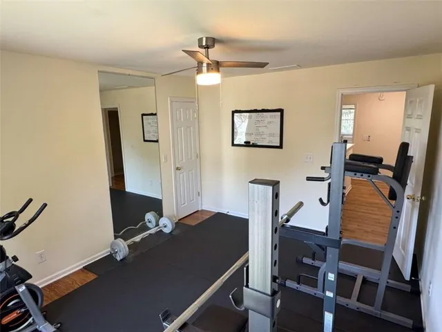 a view of a hallway with wooden floor and entryway
