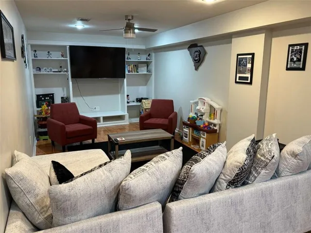 a living room with furniture and a flat screen tv
