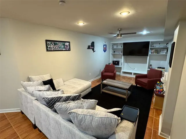 a living room with furniture a couch and a flat screen tv