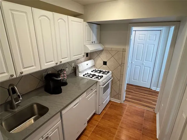 a view of hallway with livingroom and stairs