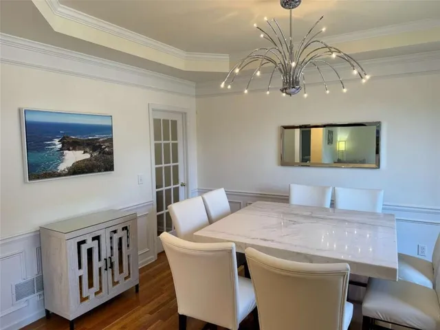 a dining room with furniture and a flat screen tv