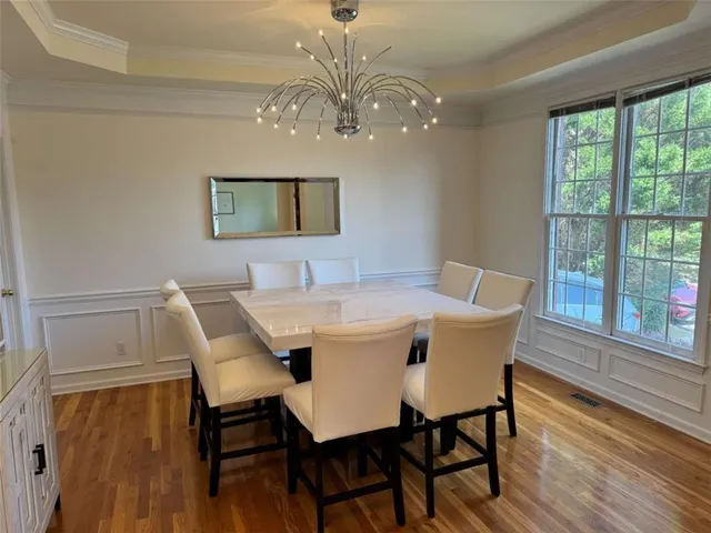 a view of a dining room with furniture and wooden floor