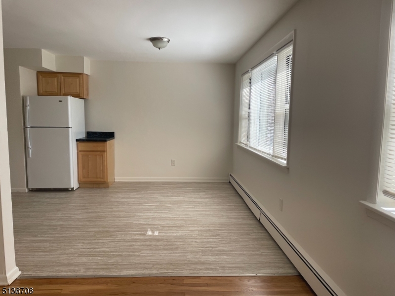 948 Valley Road, Unit A7 Clifton, NJ 07013 - Photo 3 of 9 a view of empty room with wooden floor and window