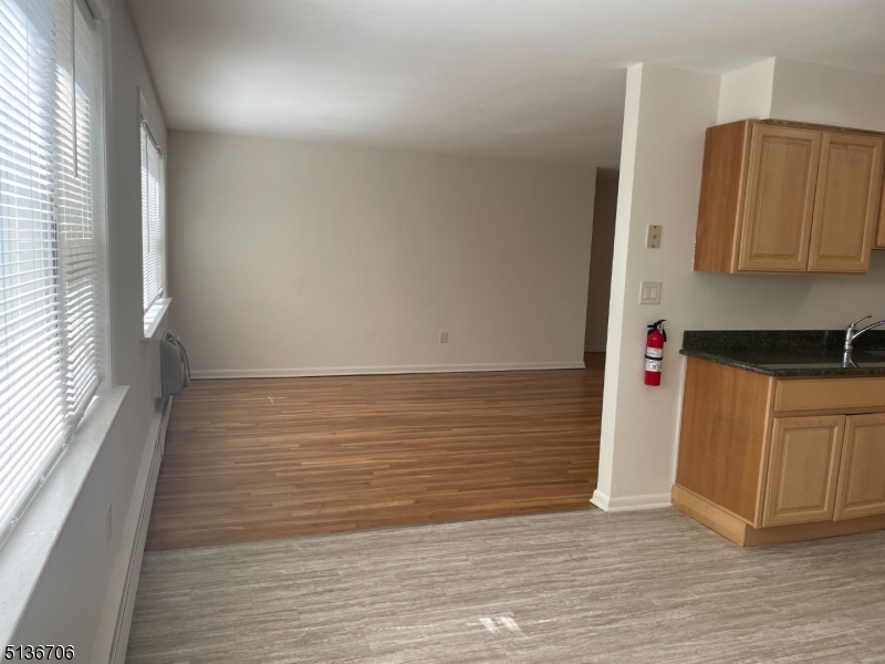 948 Valley Road, Unit A7 Clifton, NJ 07013 - Photo 9 of 9 a view of an empty room and wooden floor