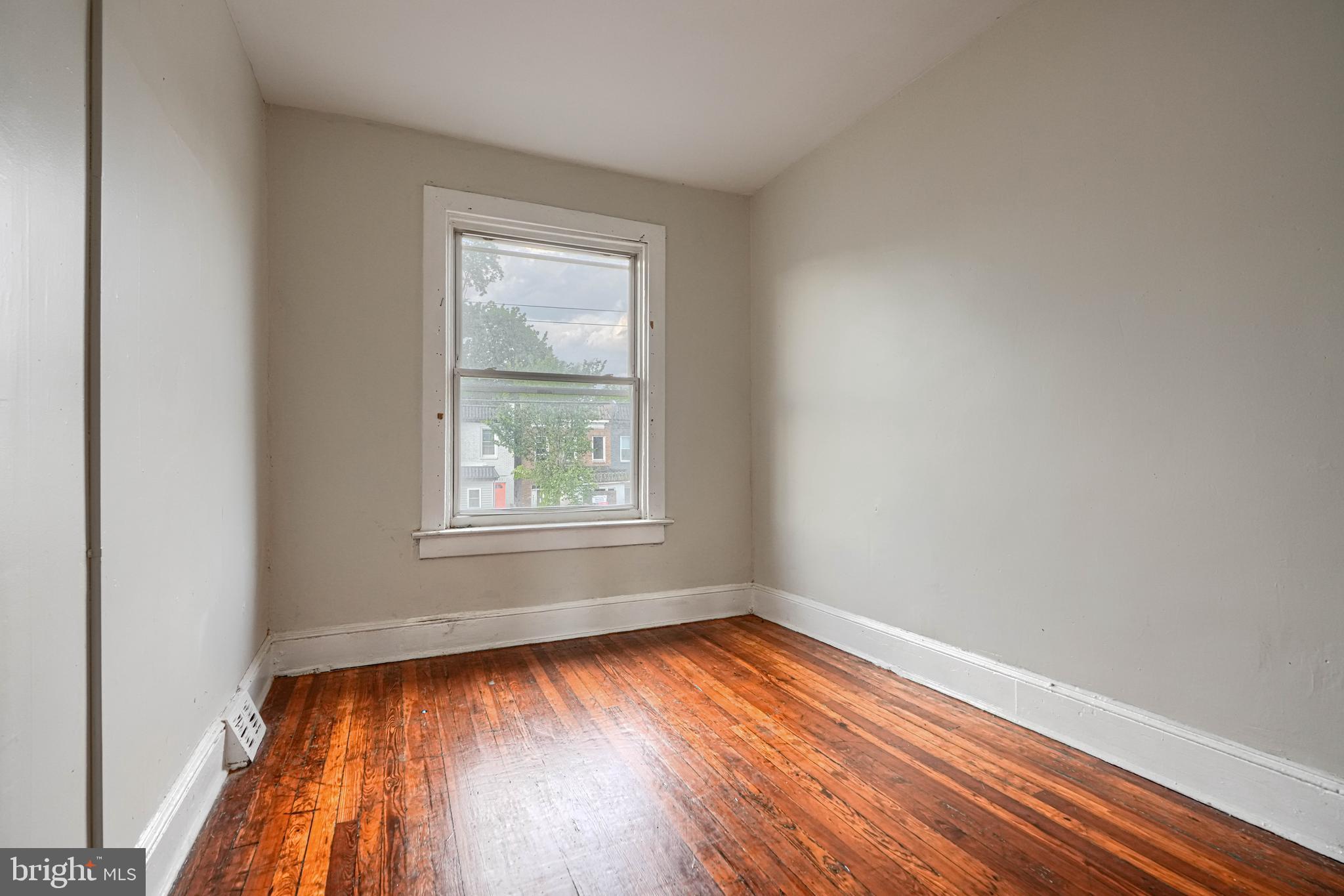 4806 Reisterstown Road Baltimore, MD 21215 - Photo 25 of 34 wooden floor in an empty room with a window