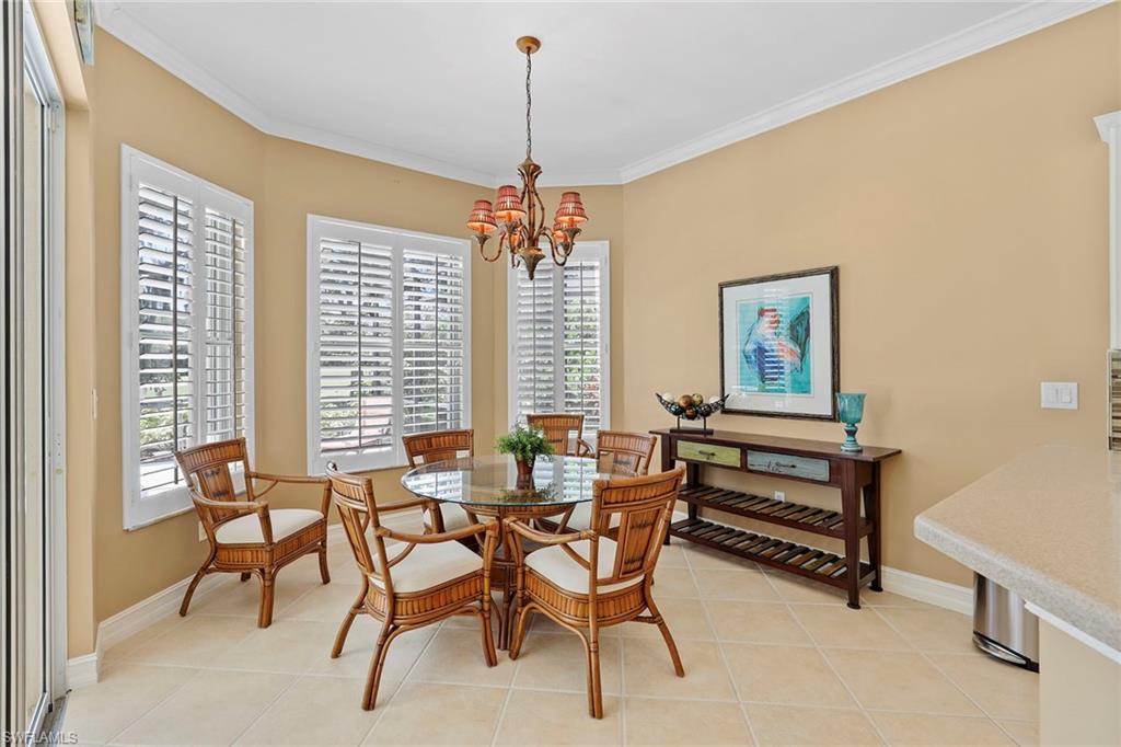 6769 Bent Grass Drive Naples, FL 34113 - Photo 11 of 32 a dining room with furniture and window