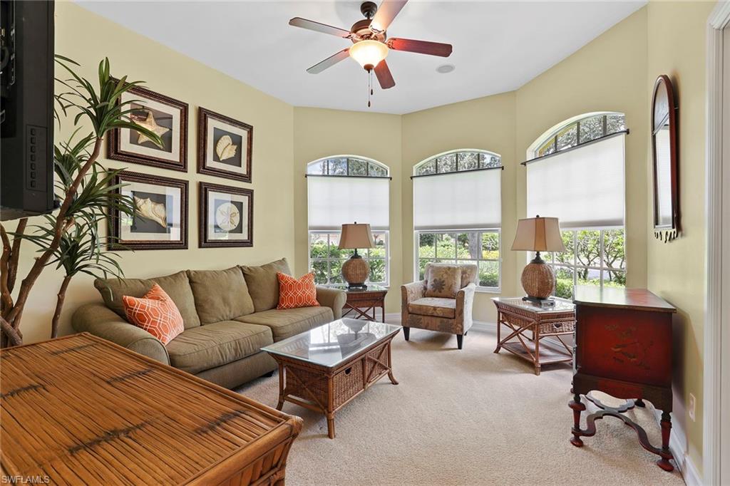 6769 Bent Grass Drive Naples, FL 34113 - Photo 12 of 32 a living room with furniture and a large window