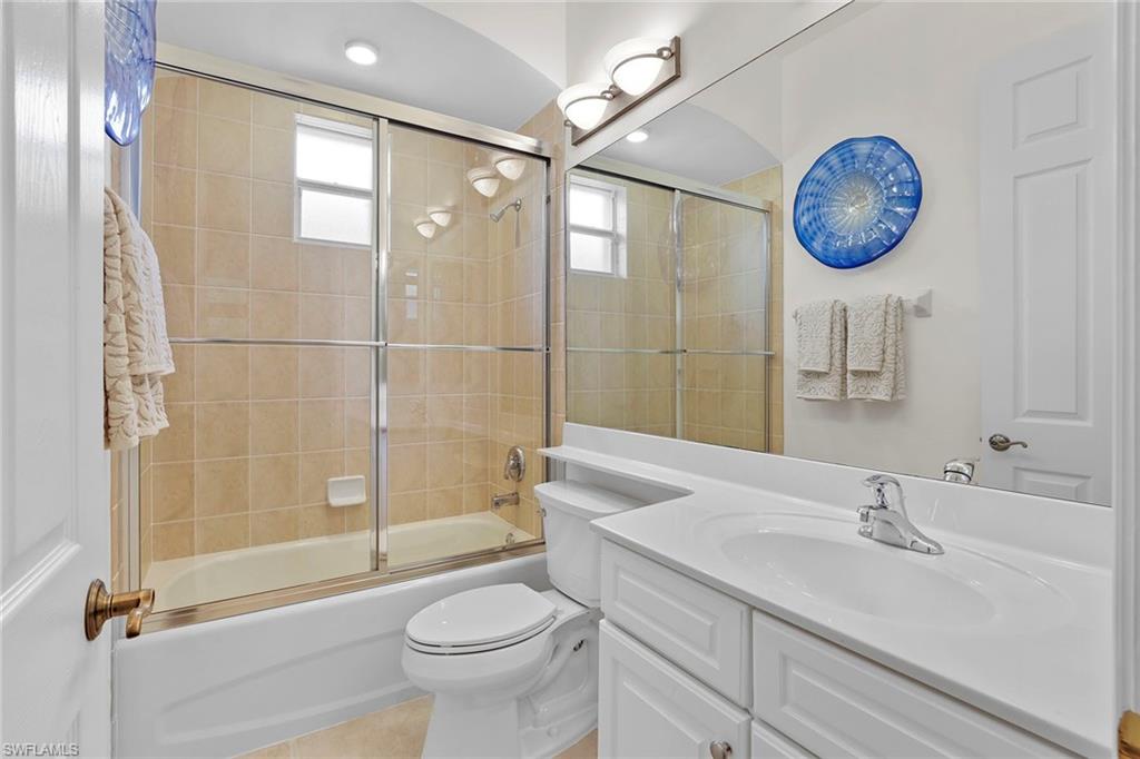 6769 Bent Grass Drive Naples, FL 34113 - Photo 16 of 32 a bathroom with a sink a toilet and a shower