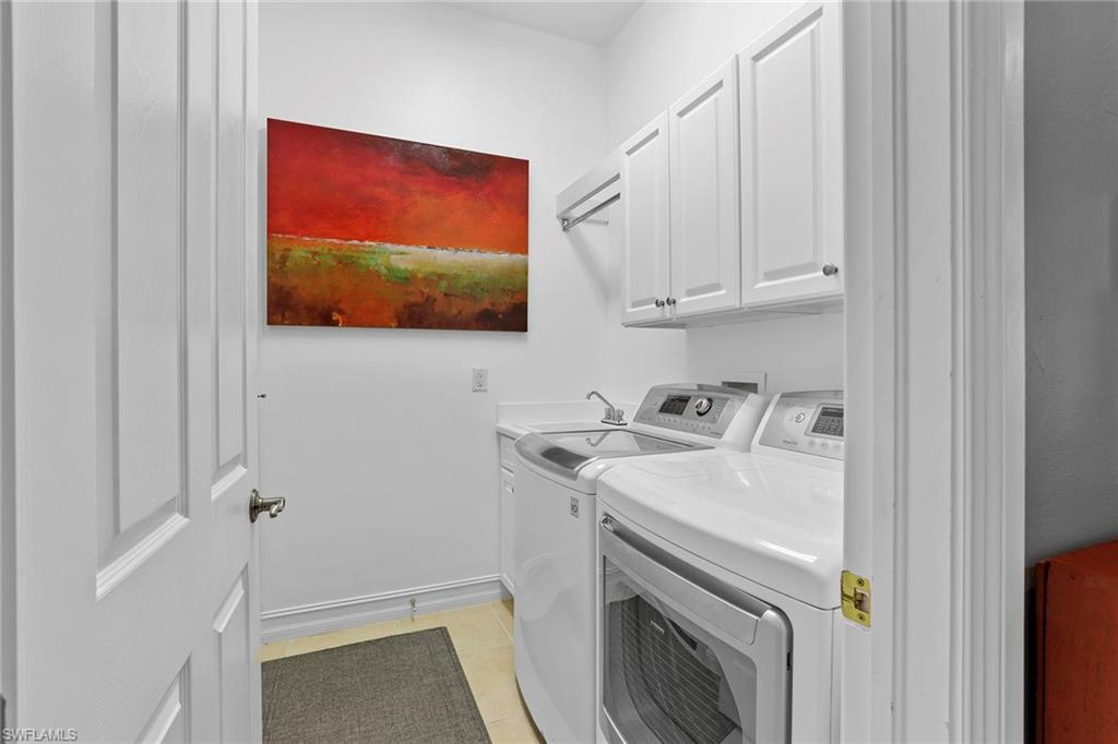 6769 Bent Grass Drive Naples, FL 34113 - Photo 17 of 32 a utility room with dryer and washer