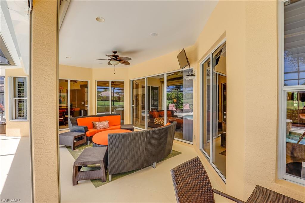 6769 Bent Grass Drive Naples, FL 34113 - Photo 21 of 32 a living room with furniture and a large window