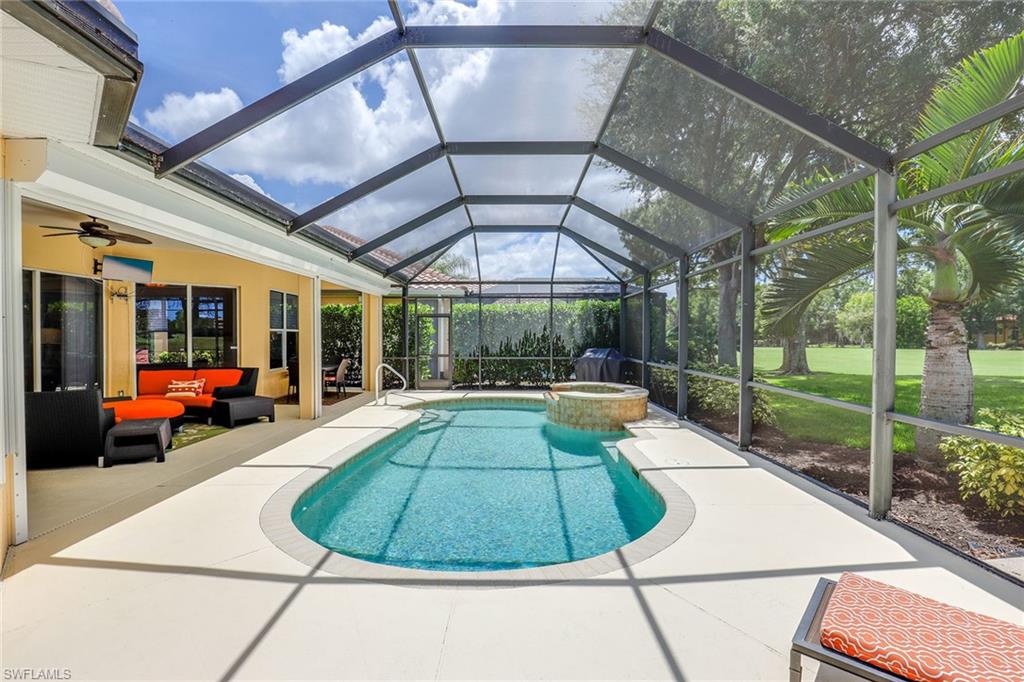 6769 Bent Grass Drive Naples, FL 34113 - Photo 24 of 32 a view of a swimming pool with a lounge chairs in patio