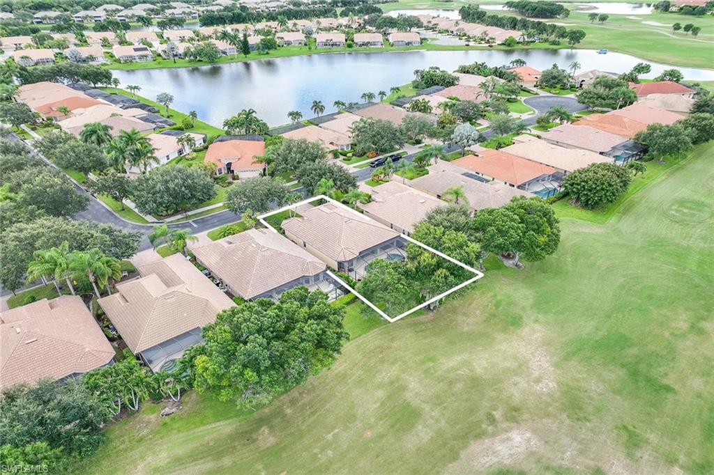 6769 Bent Grass Drive Naples, FL 34113 - Photo 30 of 32 an aerial view of a house with outdoor space and lake view