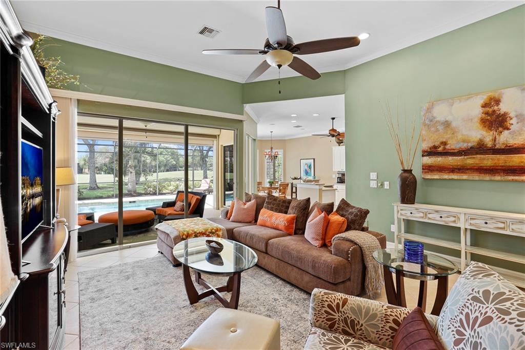 6769 Bent Grass Drive Naples, FL 34113 - Photo 8 of 32 a living room with furniture ceiling fan and a rug
