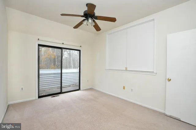 a view of a ceiling fan and a window in a room