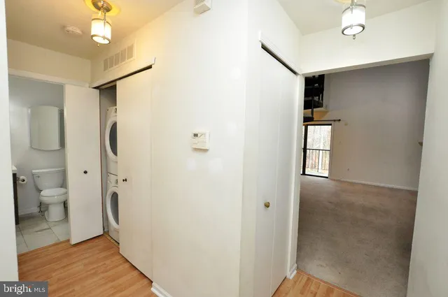 a bathroom with a glass door shower a sink and a toilet