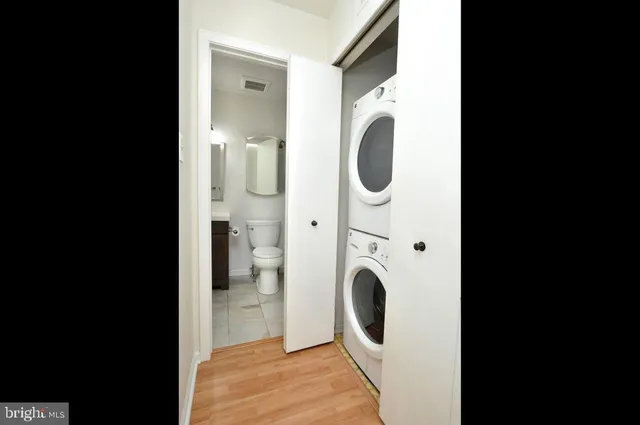 a view of a hallway with washer and dryer