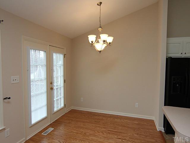 8001 Tobin Place Raleigh, NC 27612 - Photo 5 of 12 Hardwood floors, beautiful chandelier and door to back deck.