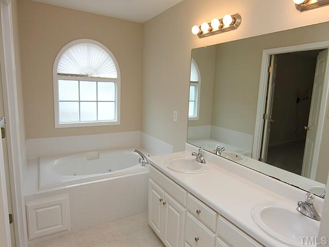 8001 Tobin Place Raleigh, NC 27612 - Photo 8 of 12 Kohler whirlpool bath, separate shower, and dual vanity.