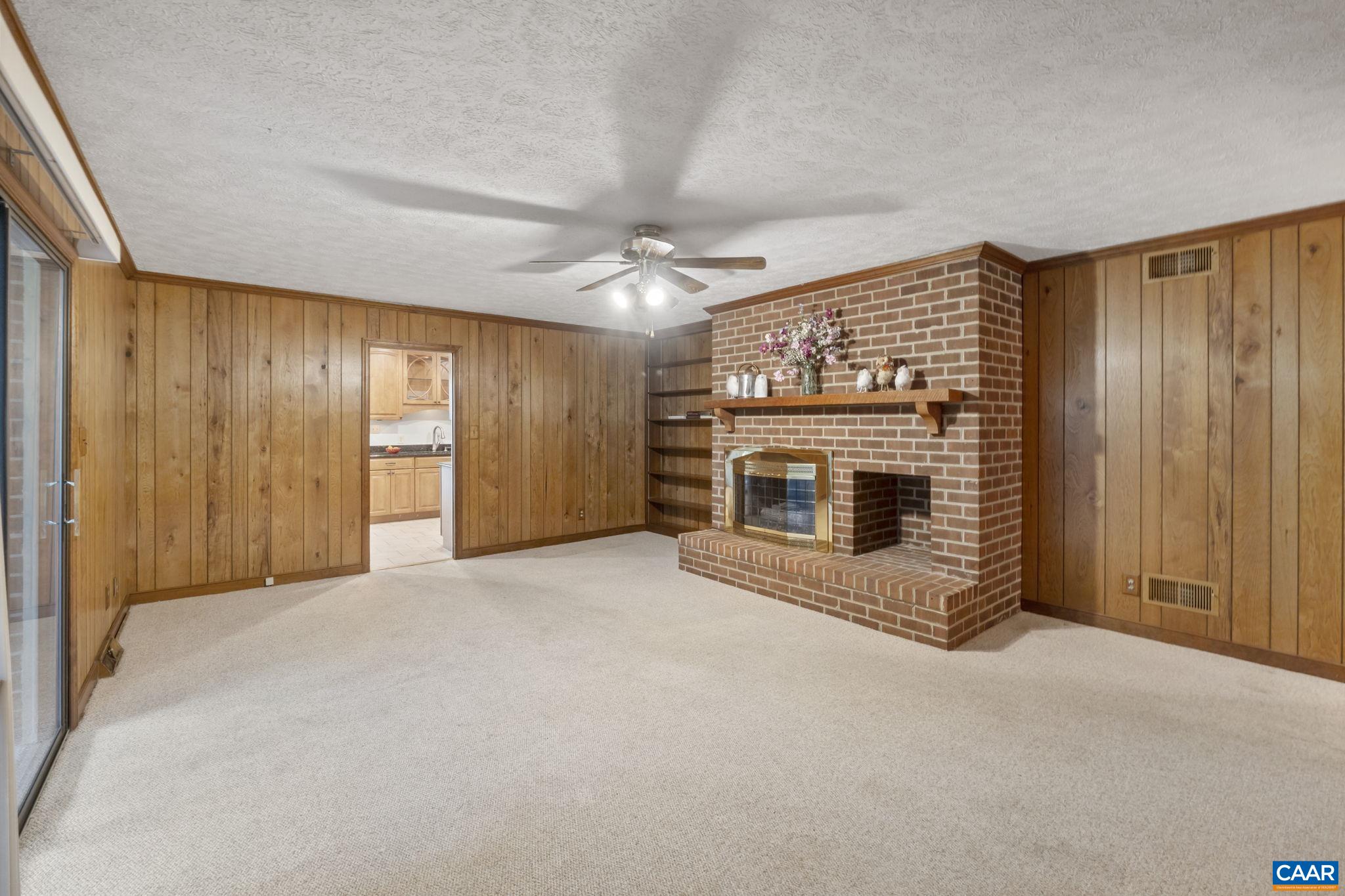 1211 Lanetown Road Crozet, VA 22932 - Photo 22 of 50 an empty room with a fireplace and cabinet