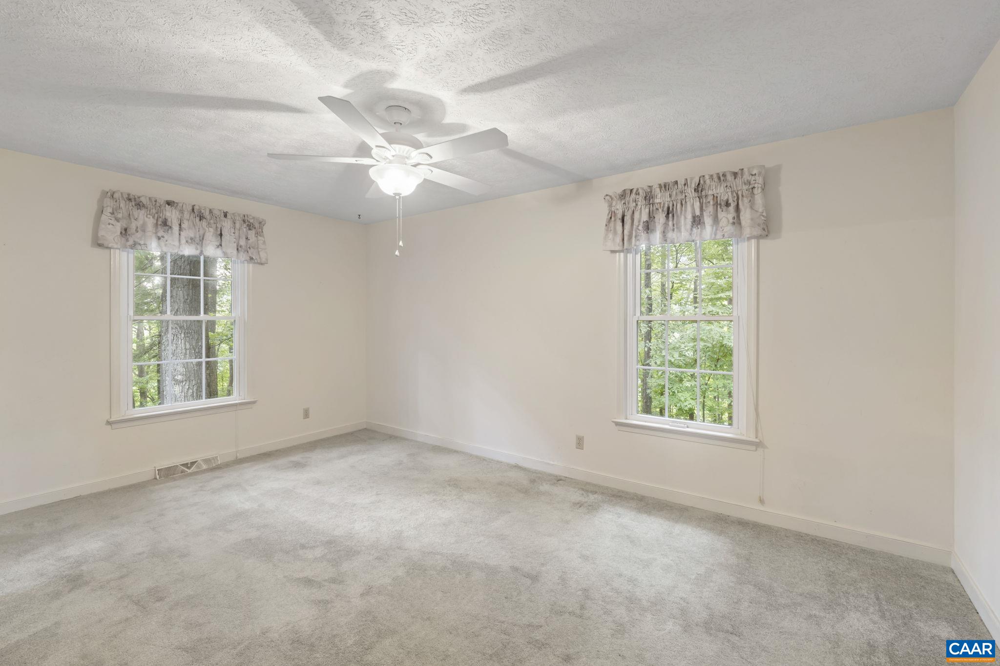 1211 Lanetown Road Crozet, VA 22932 - Photo 31 of 50 an empty room with windows and chandelier fan