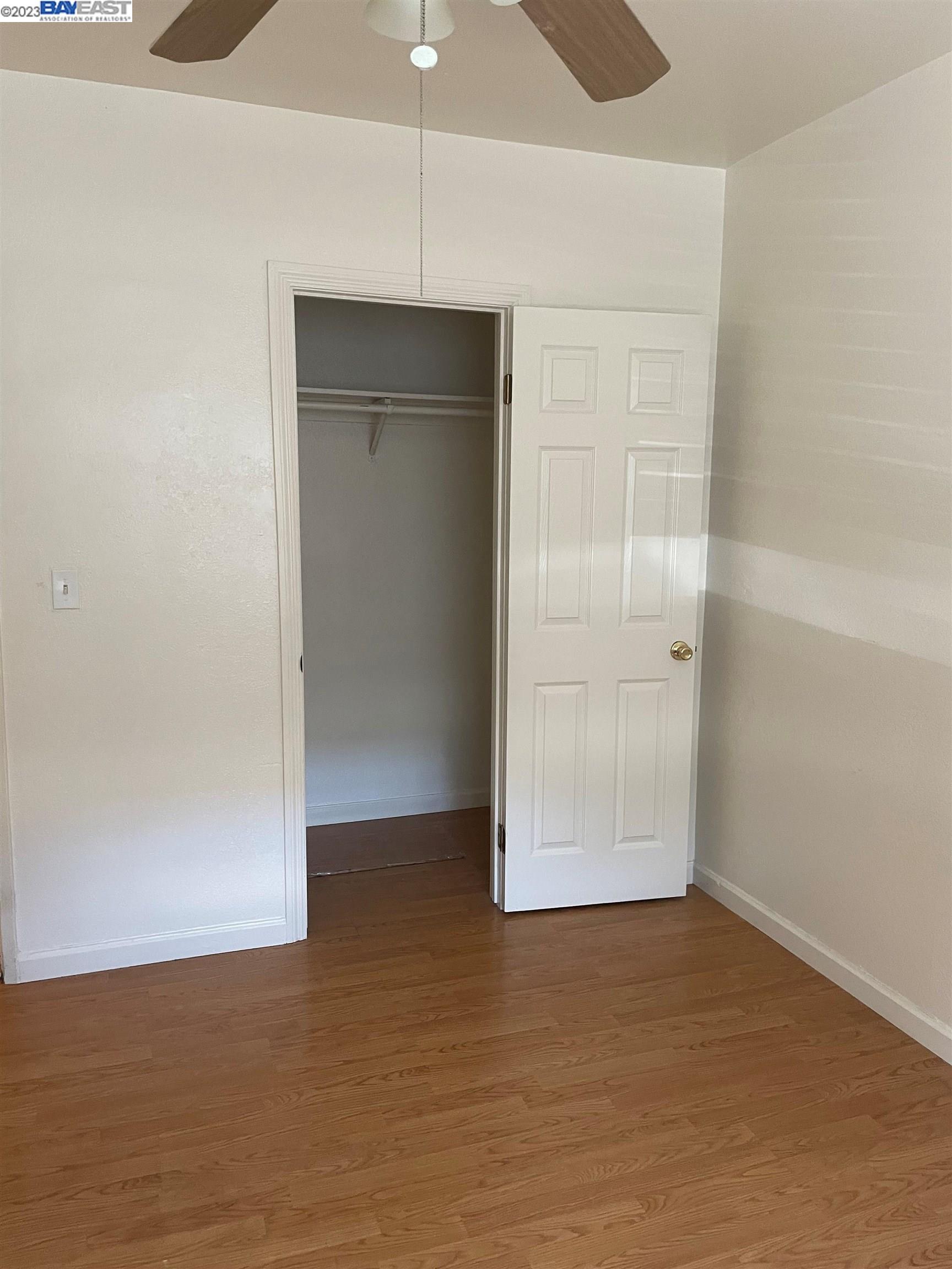 2836 Pixie Drive Stockton, CA 95203 - Photo 4 of 10 an empty room with wooden floor and closet