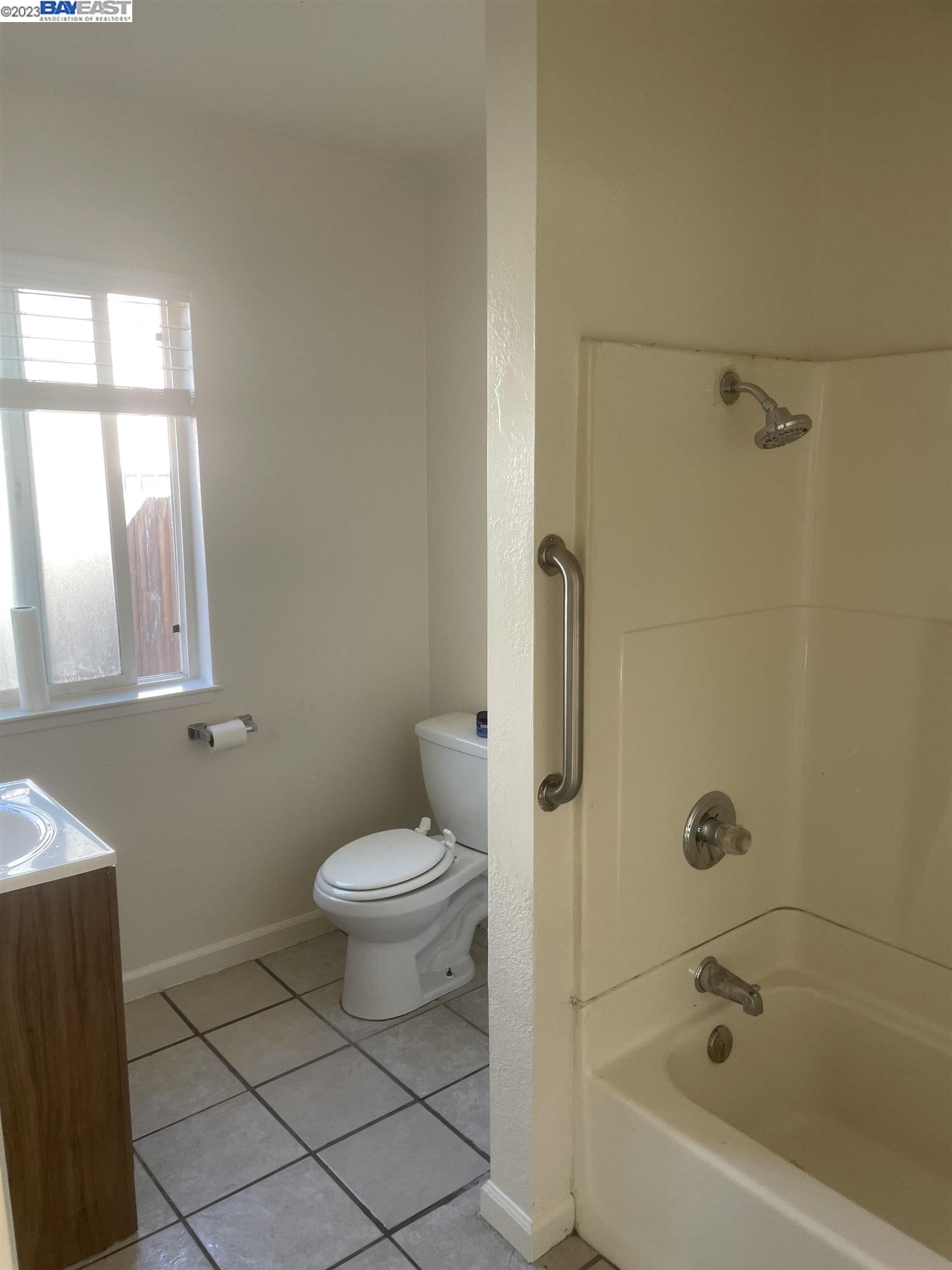 2836 Pixie Drive Stockton, CA 95203 - Photo 5 of 10 a bathroom with a bathtub toilet and window
