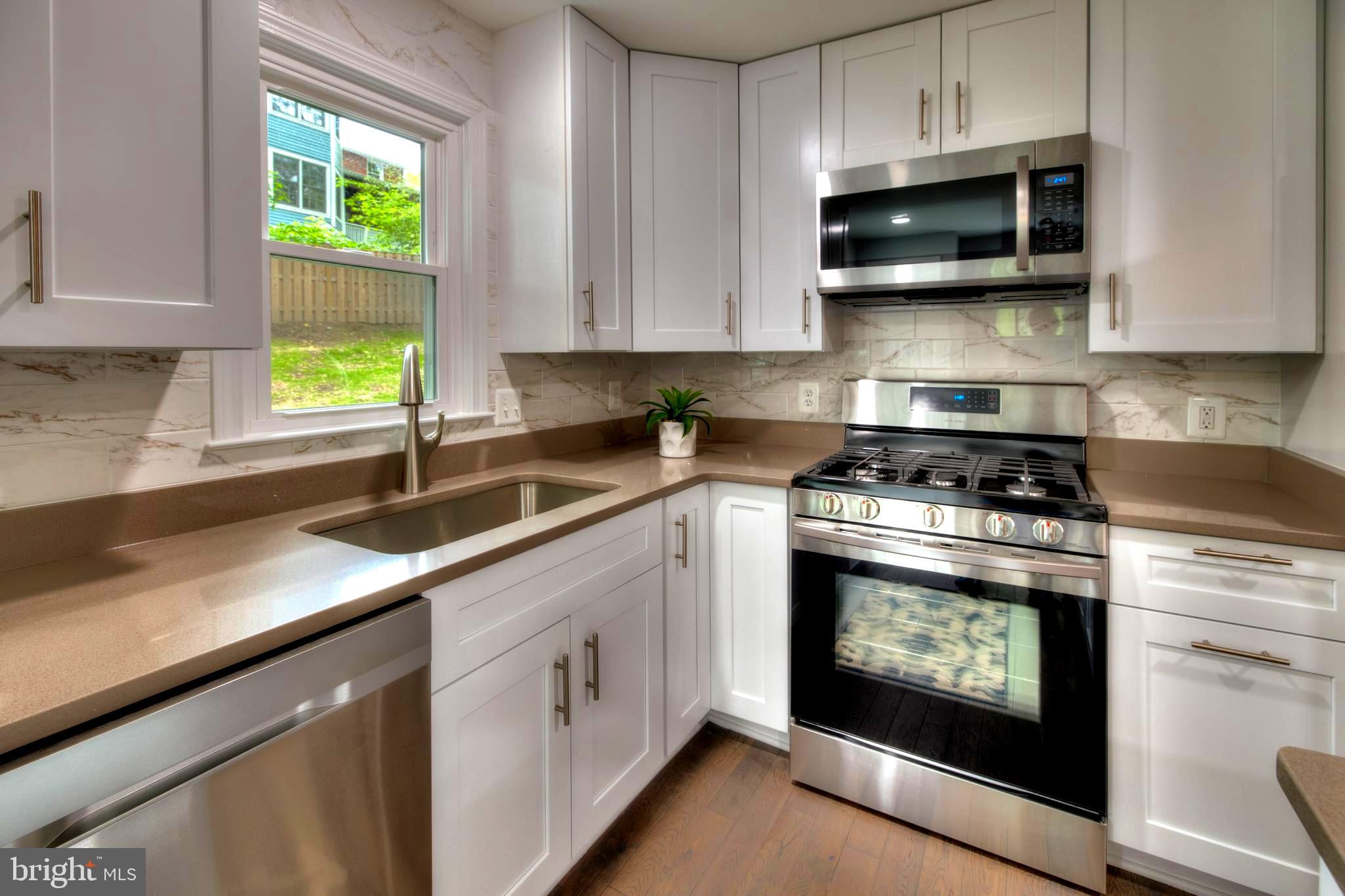 8710 Reading Road Silver Spring, MD 20901 - Photo 11 of 37 IMPORTED CERAMIC BACKSPLASH, CORIAN COUNTERTOPS