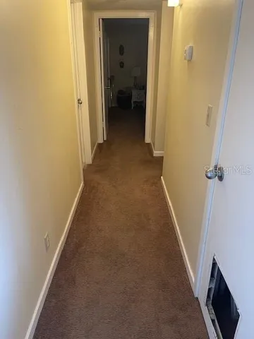 a view of hallway with livingroom