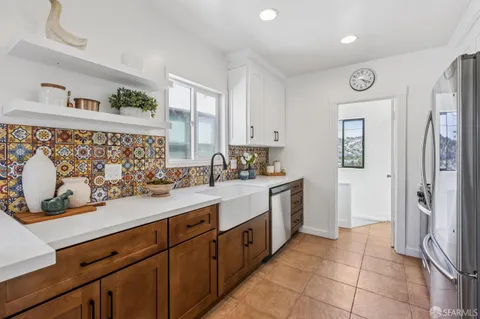 a kitchen with a sink and refrigerator