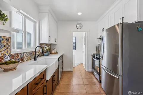 a kitchen with stainless steel appliances a refrigerator and a sink