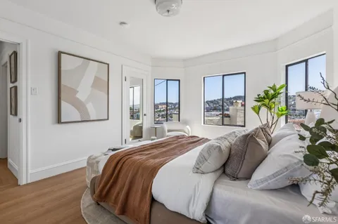 a bedroom with a bed and glass windows