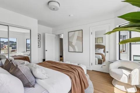a bedroom with a bed couch and a window