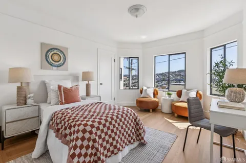 a bedroom with a bed and glass window