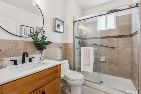 a bathroom with a sink toilet and shower