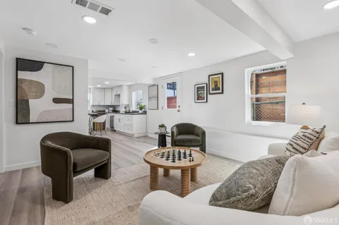 a living room with furniture and a potted plant