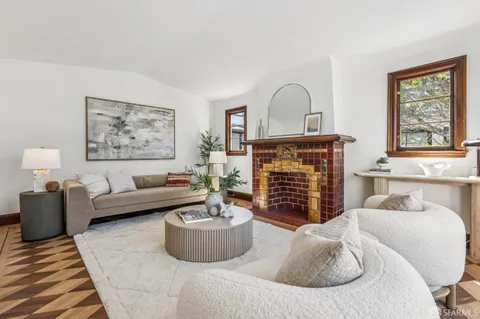 a living room with furniture a couch and a fireplace