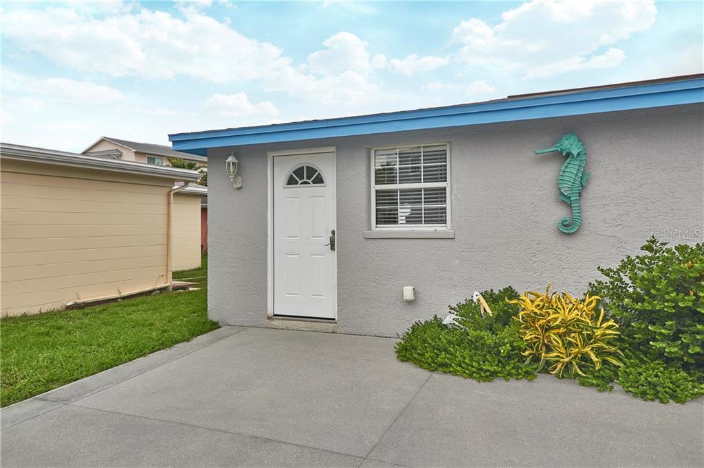 18040 5th Street East, Unit SOUTH Redington Shores, FL 33708 - Photo 2 of 9 a front view of a house with a garage