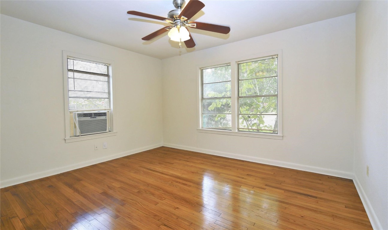 108 West Mink Street Willis, TX 77378 - Photo 11 of 12 a view of an empty room with wooden floor and a window